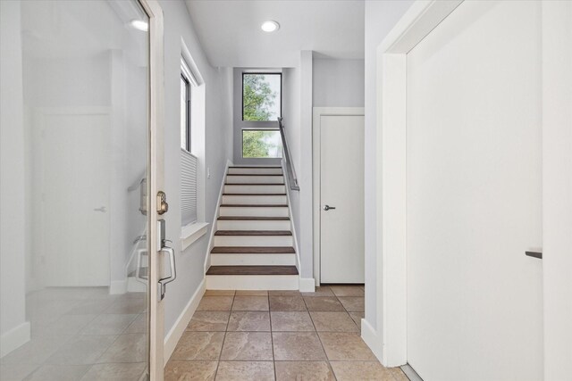 stairs featuring light tile floors