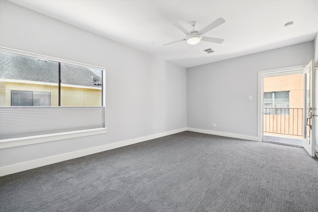 unfurnished room featuring dark carpet and ceiling fan