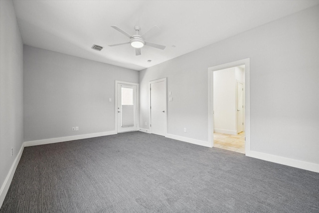 spare room with carpet, ceiling fan, and ensuite bath