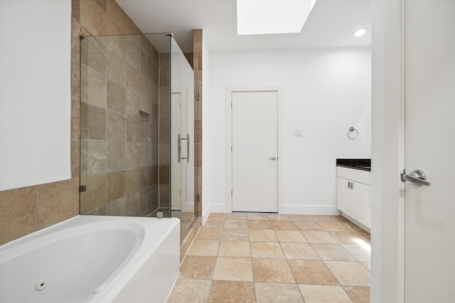 bathroom with a skylight, tile flooring, vanity, and independent shower and bath