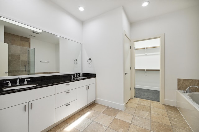 bathroom featuring tile floors, separate shower and tub, and dual bowl vanity