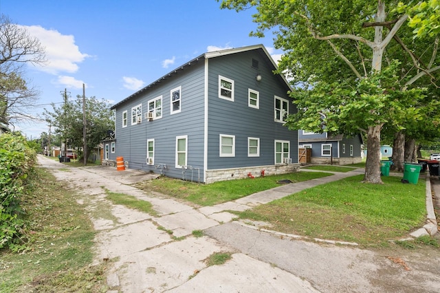 view of side of property with a yard