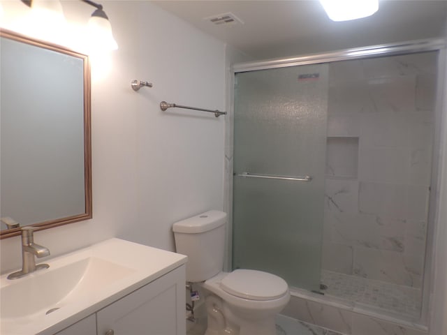 bathroom with toilet, an enclosed shower, and vanity