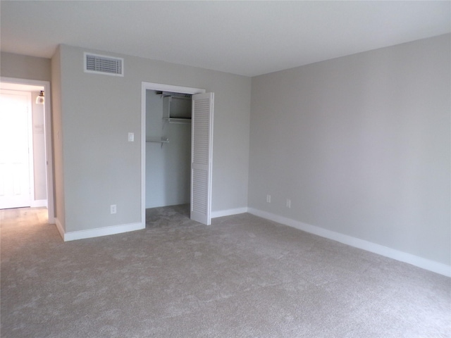 unfurnished bedroom featuring carpet floors and a closet