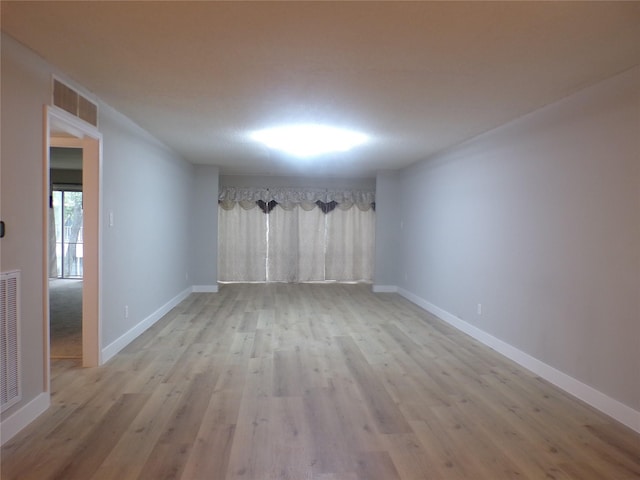 spare room featuring light hardwood / wood-style flooring