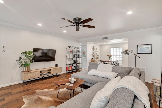 living room with hardwood / wood-style floors, ceiling fan, and ornamental molding