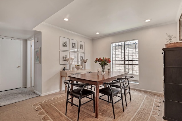 tiled dining space featuring ornamental molding