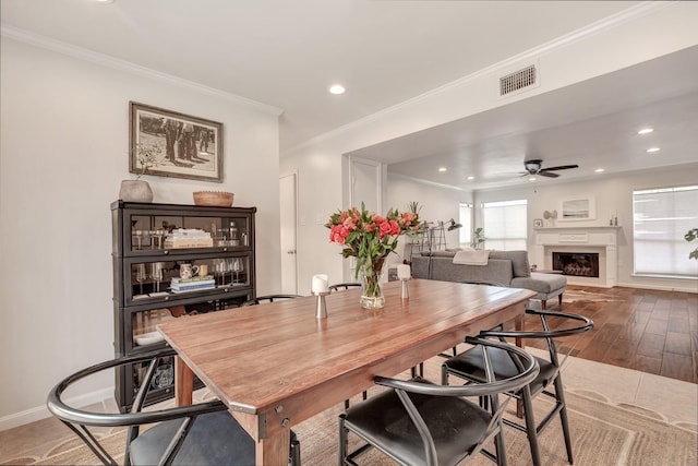 dining room featuring ceiling fan, wood-type flooring, and ornamental molding