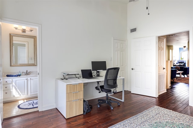 office with sink and dark wood-type flooring