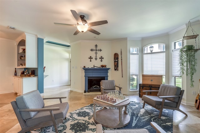 living room with ceiling fan, crown molding, and light tile patterned flooring