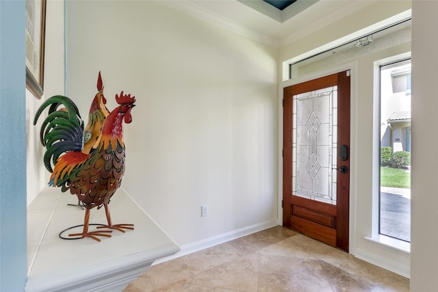 foyer featuring a wealth of natural light and crown molding