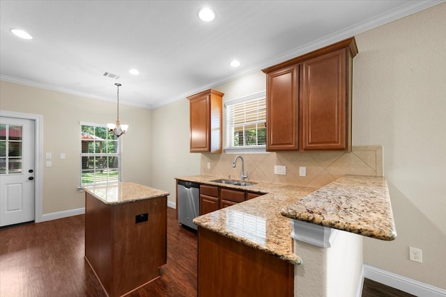 kitchen featuring dark wood-type flooring, backsplash, kitchen peninsula, and hanging light fixtures