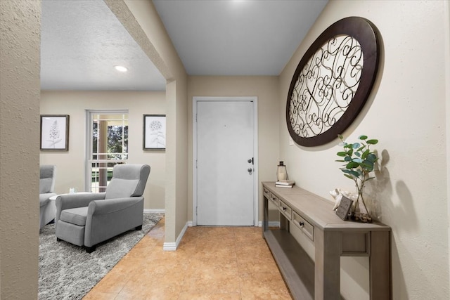 foyer with a textured ceiling