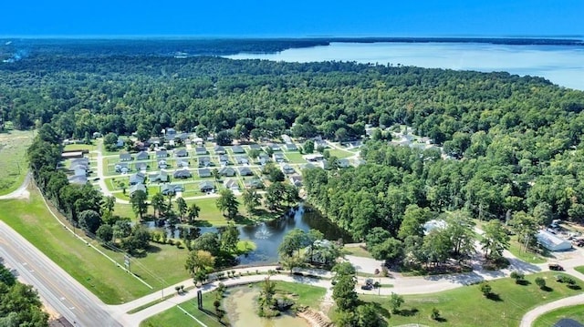 bird's eye view with a wooded view and a water view