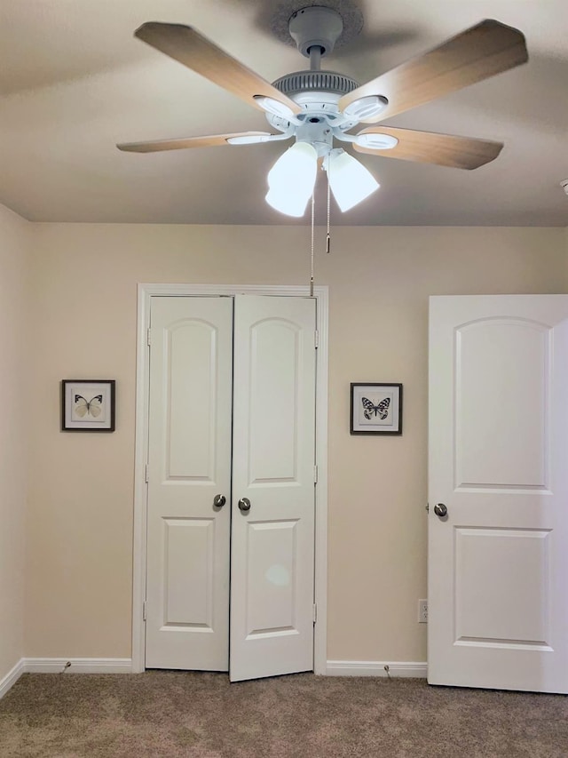 unfurnished bedroom featuring carpet floors, a closet, and ceiling fan