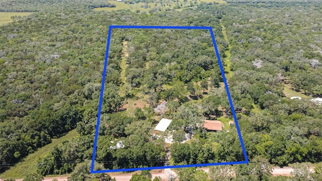 drone / aerial view featuring a forest view