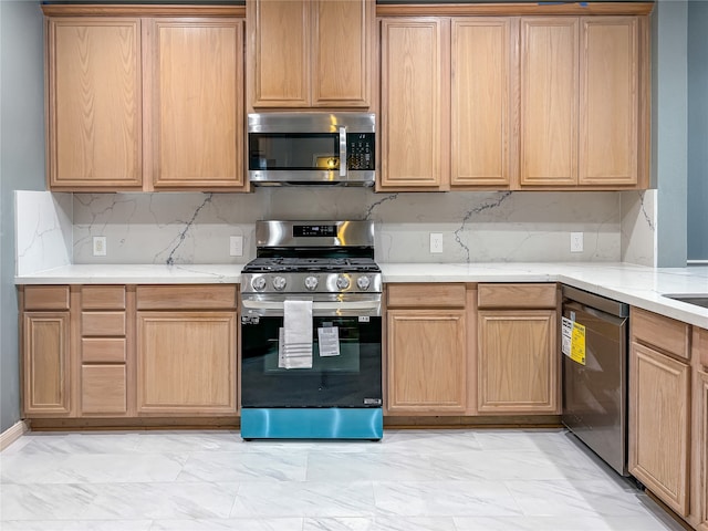 kitchen with backsplash and appliances with stainless steel finishes