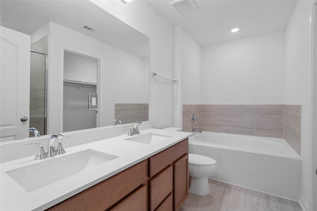 full bathroom with vanity, toilet, and independent shower and bath