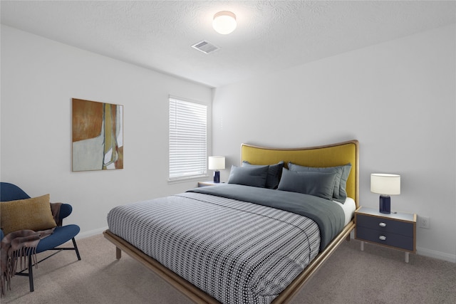 bedroom with a textured ceiling and carpet floors