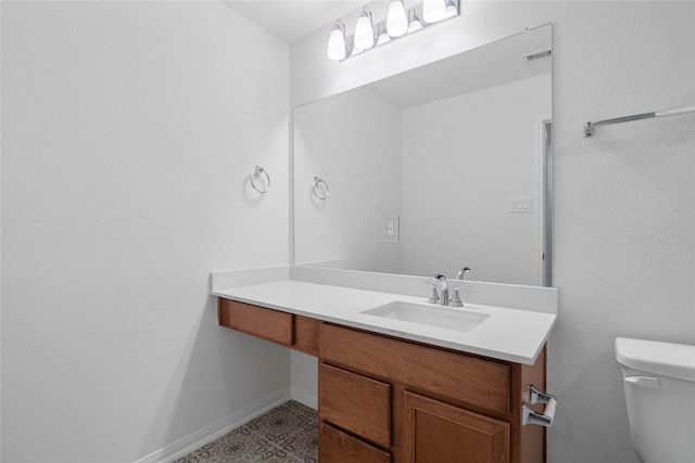 bathroom with toilet and vanity