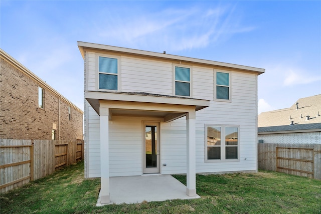 rear view of house featuring a patio and a lawn