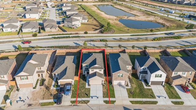 birds eye view of property with a water view