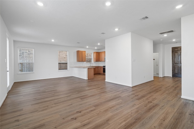 unfurnished living room featuring wood-type flooring