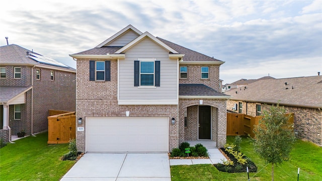 view of front of property with a front lawn and a garage