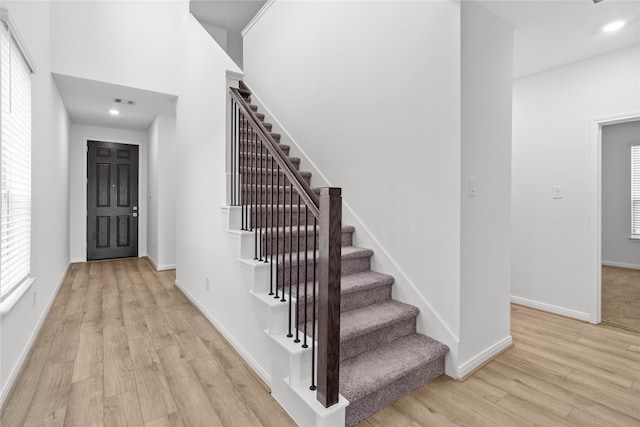 staircase with wood-type flooring