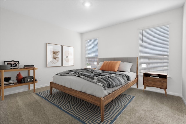 bedroom featuring multiple windows and carpet floors