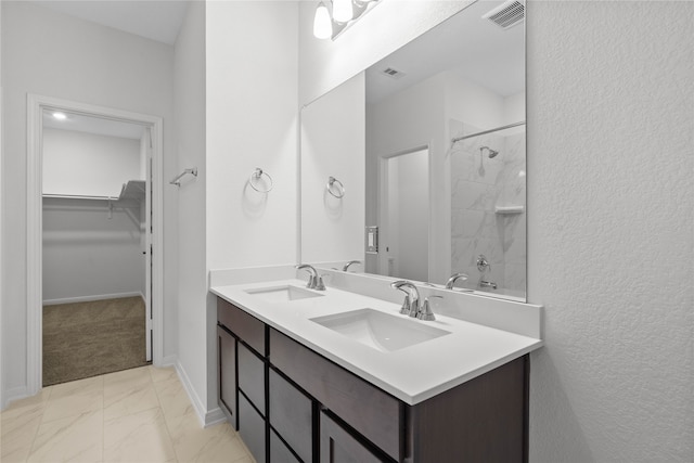 bathroom featuring vanity and tiled shower