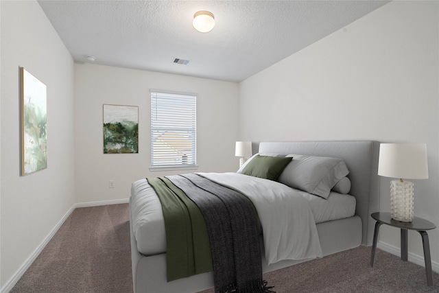 carpeted bedroom with a textured ceiling