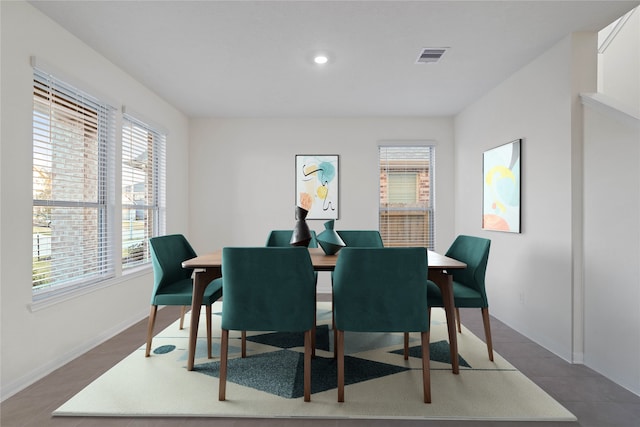 dining space featuring dark tile patterned floors