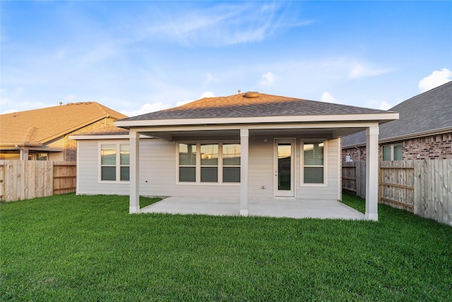 back of property featuring a patio and a lawn