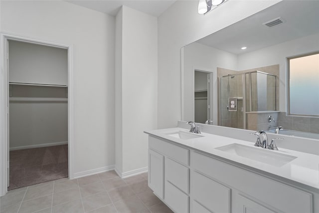 bathroom with vanity, tile patterned floors, and a shower with shower door