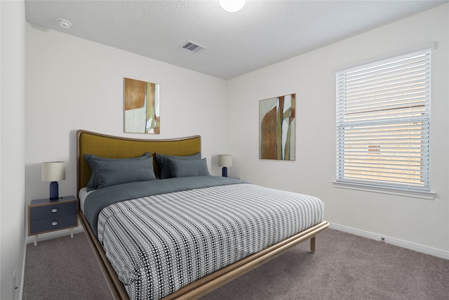 bedroom featuring carpet flooring and multiple windows