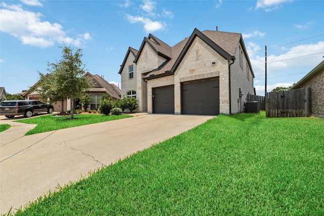 french country style house with central AC and a front lawn