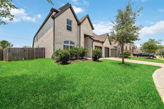 view of side of property with a yard and a garage