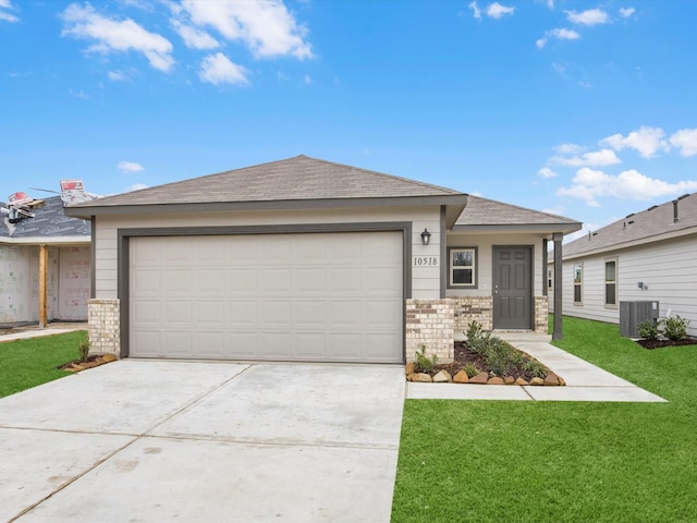 single story home with a garage, central air condition unit, and a front lawn