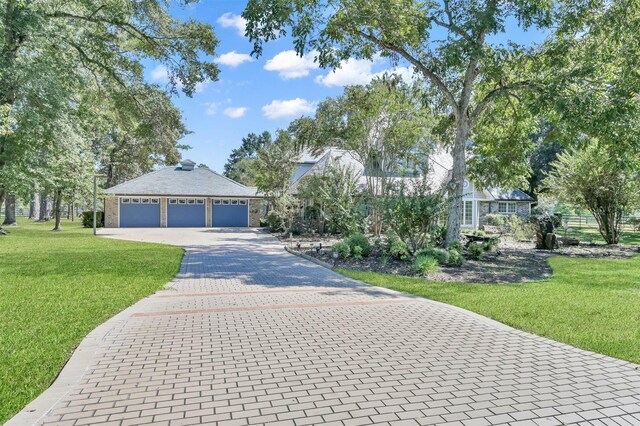 view of front facade with a garage and a front lawn