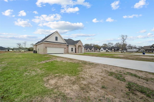 view of front of house featuring a front yard and a garage