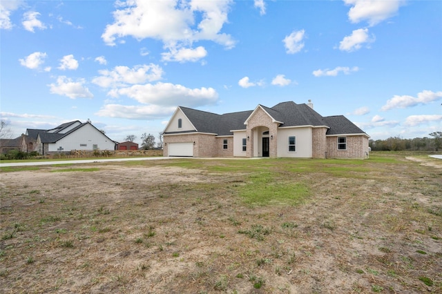 view of front of house featuring a front yard and a garage