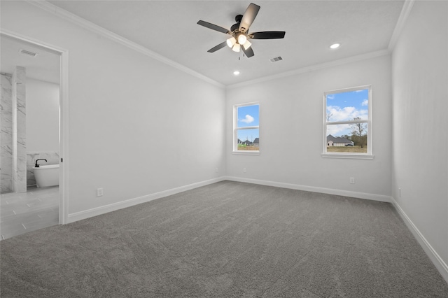 empty room featuring a healthy amount of sunlight, crown molding, and light carpet