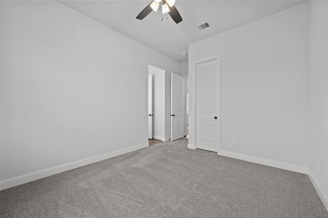 spare room with ceiling fan and light carpet