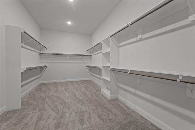 walk in closet featuring light carpet