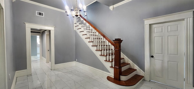 stairs with ornamental molding and a notable chandelier