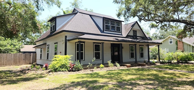 view of front of house with covered porch and a front yard