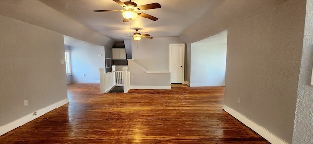 unfurnished living room featuring hardwood / wood-style flooring, vaulted ceiling, and ceiling fan