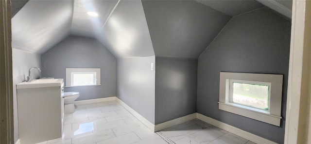 bathroom with vanity, vaulted ceiling, and toilet