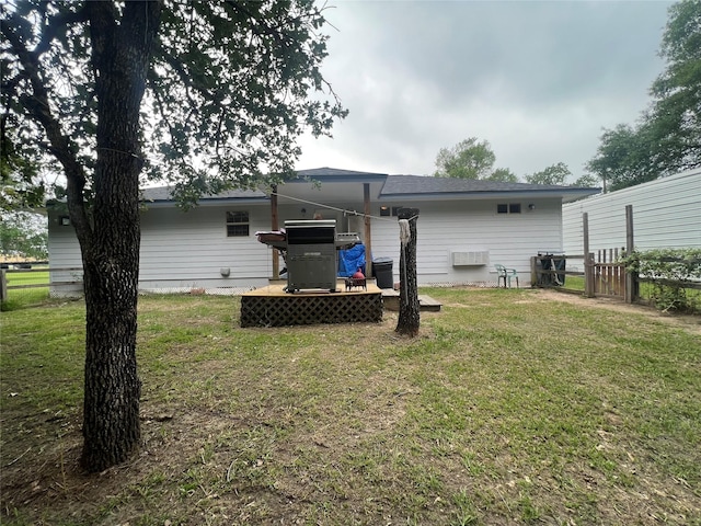 rear view of property featuring a lawn